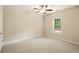 Standard bedroom with carpet, a ceiling fan, a window, and painted walls, suitable for various layouts at 8056 Revere Dr, Mcdonough, GA 30252