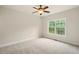 Neutral bedroom with carpet, a ceiling fan, and large window providing ample natural light at 8056 Revere Dr, Mcdonough, GA 30252