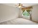Bedroom with neutral walls, a ceiling fan and a window with decorative curtains at 8056 Revere Dr, Mcdonough, GA 30252