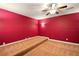 Carpeted bonus room featuring a unique elevated platform and vibrant red walls, adding character to the space at 8056 Revere Dr, Mcdonough, GA 30252