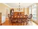 Formal dining room with elegant chandelier, hardwood floors, and large windows at 8056 Revere Dr, Mcdonough, GA 30252