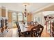 Formal dining room with elegant chandelier, hardwood floors, and large windows at 8056 Revere Dr, Mcdonough, GA 30252