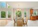 Bright dining area with tile floors and views of the deck and the kitchen at 8056 Revere Dr, Mcdonough, GA 30252