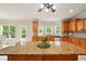 Large kitchen featuring center island, lots of cabinets, stainless appliances, and exterior access to deck at 8056 Revere Dr, Mcdonough, GA 30252