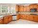 Kitchen with wood cabinets, stainless dishwasher, lots of natural light, and breakfast nook at 8056 Revere Dr, Mcdonough, GA 30252