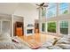 Inviting living room features hardwood floors, fireplace, and large windows with natural light at 8056 Revere Dr, Mcdonough, GA 30252