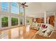 Bright open-concept living space with large windows, hardwood floors, and a comfortable sofa at 8056 Revere Dr, Mcdonough, GA 30252