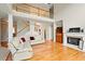 Bright living room boasts hardwood floors, a fireplace, and staircase to second floor at 8056 Revere Dr, Mcdonough, GA 30252