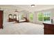 Spacious primary bedroom with tray ceilings and sitting area with large windows at 8056 Revere Dr, Mcdonough, GA 30252