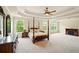 Spacious primary bedroom with tray ceilings, fireplace and sitting area with plenty of natural light at 8056 Revere Dr, Mcdonough, GA 30252