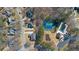 Aerial view showcasing homes, pool, tennis courts and playground within a beautiful neighborhood at 8424 Fairway Dr, Covington, GA 30014