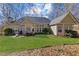 Expansive backyard offering a lush lawn, patio area with seating, and serene landscaping at 8424 Fairway Dr, Covington, GA 30014