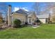 Scenic backyard featuring a well-maintained lawn, patio seating, and lush landscaping at 8424 Fairway Dr, Covington, GA 30014
