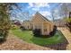 Landscaped backyard featuring a well-kept lawn, patio area, and lush trees at 8424 Fairway Dr, Covington, GA 30014