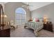 Bedroom featuring a wrought iron bed, a large window, and a cozy chair at 8424 Fairway Dr, Covington, GA 30014