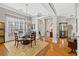 Traditional dining room featuring hardwood floors, neutral walls, chandelier and glass top table at 8424 Fairway Dr, Covington, GA 30014