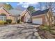 Beautiful brick home with a well-manicured lawn, a two-car garage, and an ample driveway at 8424 Fairway Dr, Covington, GA 30014