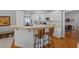 Kitchen with breakfast bar featuring white cabinets, wood countertops, and bar stool seating at 8424 Fairway Dr, Covington, GA 30014