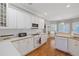 Bright kitchen featuring white cabinets, wood countertops, and modern appliances at 8424 Fairway Dr, Covington, GA 30014