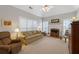 Bright living room with a fireplace, vaulted ceiling, and neutral carpeting at 8424 Fairway Dr, Covington, GA 30014
