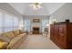 Bright living room with a fireplace, vaulted ceiling, and neutral carpeting at 8424 Fairway Dr, Covington, GA 30014