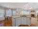 Open concept living room with a fireplace, vaulted ceiling, and access to the kitchen at 8424 Fairway Dr, Covington, GA 30014
