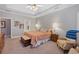 Main bedroom featuring a tray ceiling, neutral walls, and carpeted floors at 8424 Fairway Dr, Covington, GA 30014
