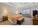 Main bedroom featuring a tray ceiling, neutral walls, and carpeted floors at 8424 Fairway Dr, Covington, GA 30014