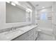 Elegant bathroom featuring double vanity, marble countertop, and a combined tub and shower at 2262 Abby Ne Ln, Atlanta, GA 30345