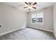 Serene bedroom featuring carpet, a ceiling fan, and a large window overlooking the neighborhood at 2262 Abby Ne Ln, Atlanta, GA 30345