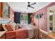 Cozy bedroom featuring plush bedding, a ceiling fan, and a view of the outdoors at 885 Briarcliff Ne Rd # 16, Atlanta, GA 30306