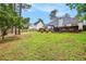 Well-manicured backyard featuring a spacious lawn, wooden fence, and a deck for outdoor dining and relaxation at 97 Old Burnt Hickory Rd, Acworth, GA 30101