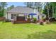 Home exterior with backyard features deck, hot tub, patio, seating and landscaped lawn at 97 Old Burnt Hickory Rd, Acworth, GA 30101