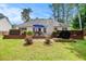 Backyard view of the home shows deck, outdoor seating, hot tub and lush green lawn at 97 Old Burnt Hickory Rd, Acworth, GA 30101
