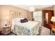 Cozy bedroom featuring a floral comforter, bedside table, and ample closet space at 97 Old Burnt Hickory Rd, Acworth, GA 30101
