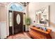 Elegant home foyer with hardwood floors, decorative mirror and lovely front door at 97 Old Burnt Hickory Rd, Acworth, GA 30101