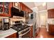 Well-equipped kitchen featuring stainless steel appliances, granite counters, and rich wood cabinetry at 97 Old Burnt Hickory Rd, Acworth, GA 30101