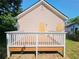 View of the home's back deck with white railings and a natural setting at 1059 Sims Sw St, Atlanta, GA 30310