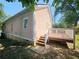 Exterior view of the house with a wooden deck and stairs leading down to the yard at 1059 Sims Sw St, Atlanta, GA 30310