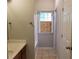 Bathroom with tile flooring, wood cabinets, and a window at 1059 Sims Sw St, Atlanta, GA 30310