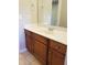 A bathroom featuring a granite counter with wood cabinets, undermount sink and a large mirror at 1059 Sims Sw St, Atlanta, GA 30310