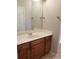 Bathroom with wood cabinets, a large mirror, and tile flooring at 1059 Sims Sw St, Atlanta, GA 30310