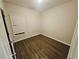 A tidy bedroom offers a double window and wood-look flooring at 1059 Sims Sw St, Atlanta, GA 30310