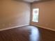Bedroom featuring wood-look flooring, neutral paint, and a window at 1059 Sims Sw St, Atlanta, GA 30310