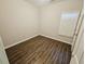 A tidy bedroom offers a double window and wood-look flooring at 1059 Sims Sw St, Atlanta, GA 30310