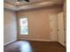 Bedroom featuring wood-look flooring, a ceiling fan, and a window at 1059 Sims Sw St, Atlanta, GA 30310