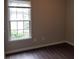 Bedroom with dark wood-look flooring, a window, and neutral paint at 1059 Sims Sw St, Atlanta, GA 30310