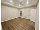 A spacious bedroom offers a tray ceiling, ceiling fan and wood-look flooring at 1059 Sims Sw St, Atlanta, GA 30310