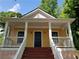 Charming home with a welcoming front porch, wooden stairs, and a colorful exterior at 1059 Sims Sw St, Atlanta, GA 30310