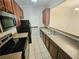 Kitchen with tile flooring, stainless steel appliances, black refrigerator, and eat in bar at 1059 Sims Sw St, Atlanta, GA 30310